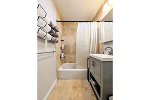 Combined shower/tub, hair dryer, towels, soap