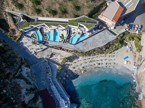 An aerial view of a resort with a pool area, beach, and a parking lot. - Made By The Sea Villas 8 Bdrm (Malevizi)