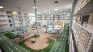 A multi-level indoor complex with balconies, a central courtyard, and a pool area. - Ocean Links - Stunning 3rd Floor Ocean View! (Hilton Head)