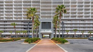 A multi-story hotel with a central entrance labeled "THE WHARF". - Gulf views! Spacious with 2 King beds, Bunk Room | 5 Pools (Panama City Beach)
