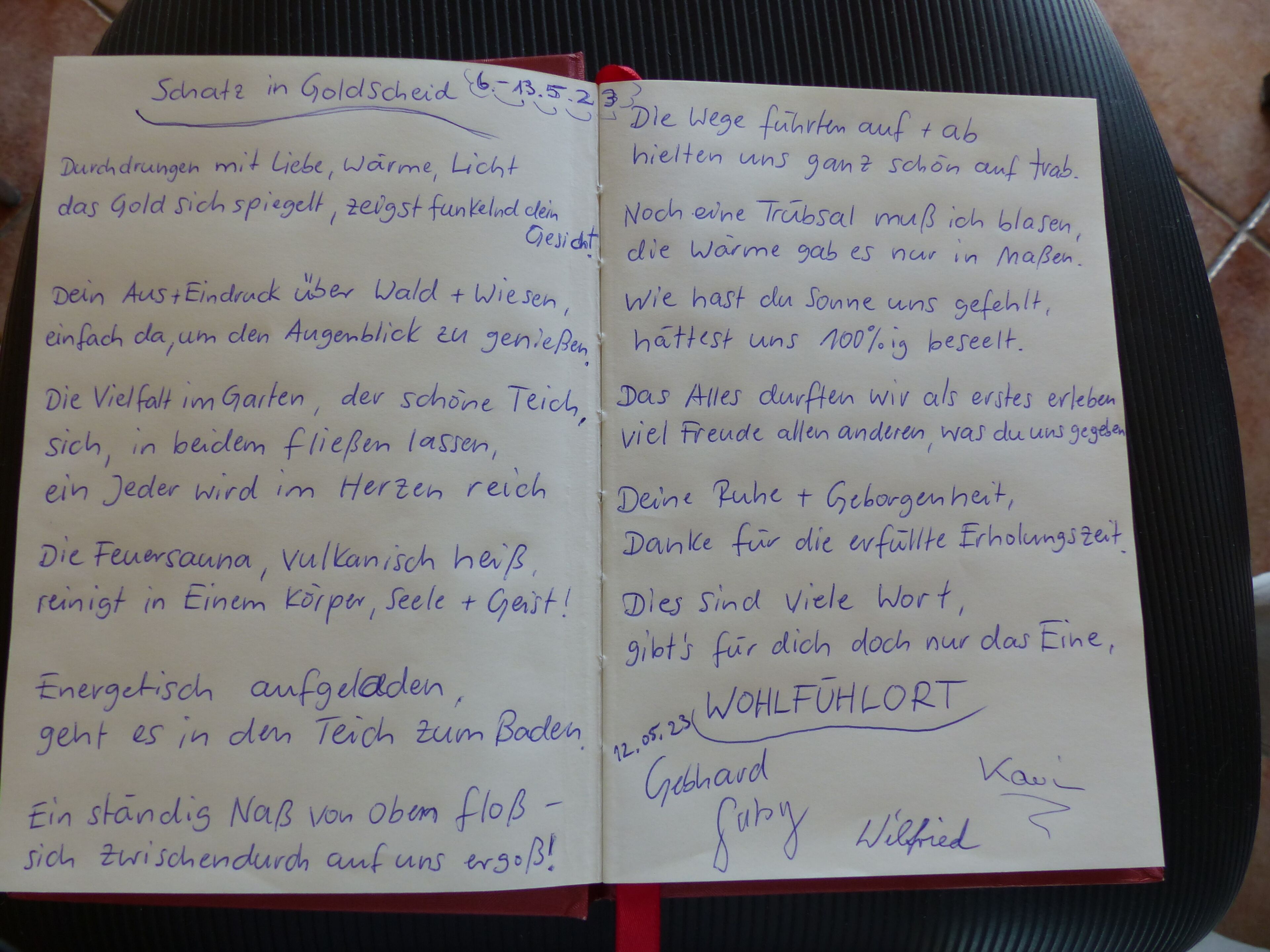 A handwritten note with text in German, possibly a guestbook entry, on a lined paper placed on a chair.