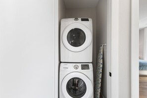 A laundry area with two stacked washing machines.