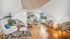 A spacious loft with high ceilings, a dining area, and a kitchen. - Gorgeous home in Læsø with kitchen (Læsø)