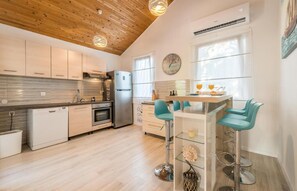 Enjoy cooking in this well-equipped kitchen with a central island and bar stools.