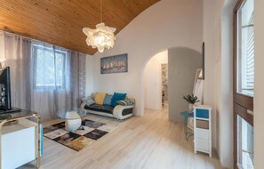 Relax in this inviting living room with a sofa, coffee table, and large window.