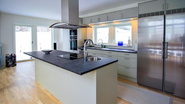 A modern kitchen with a central island, stainless steel appliances, and a view to the outside. - Stunning home in Båstad with WiFi (Båstad)