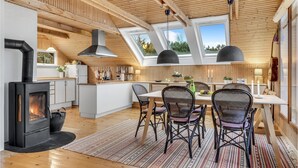 A spacious kitchen with a central island, wooden ceiling beams, and skylights. - Nice home in Kalundborg with WiFi (Kalundborg)