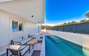 Relax by the pool with a clear view of the surrounding landscape.