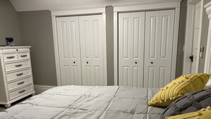 A bedroom with a bed, a dresser, and two wardrobes. - Vintage Home in Portage, WI (Portage)