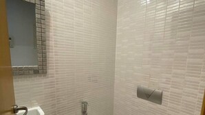 A bathroom with a white sink, a shower, and a mirror. - Apparently new ideal for family (Avignon)