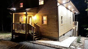 A wooden cabin with a porch, a staircase, and a small deck. - Secluded 3 bedroom Log Cabin,Kid Friendly,In Logan Ohio,in Hocking Hills,Hot Tub (Logan)