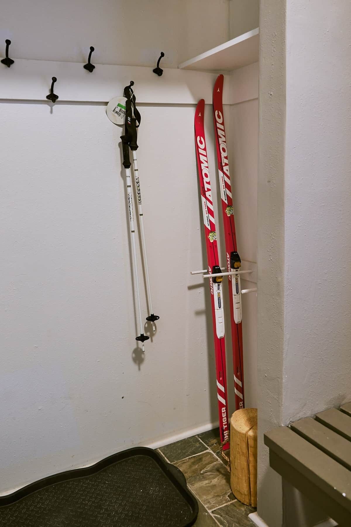 A ski storage area with skis and poles.
