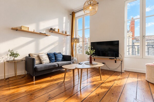 A modern living room with a sofa, coffee table, and TV.