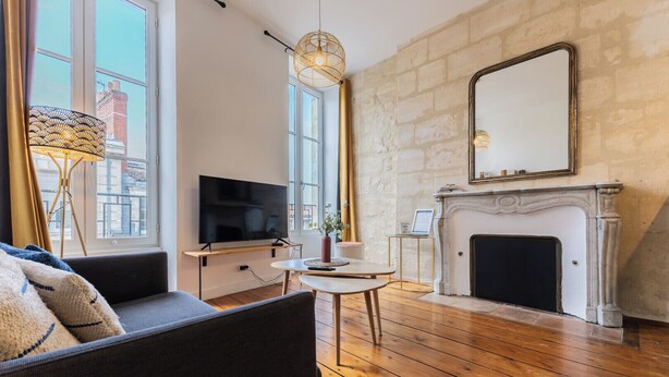 A living room with a fireplace, a television, and a sofa.