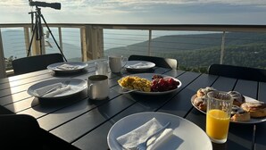 A table set with breakfast plates, a telescope, and a scenic view. - Sauna, dog friendly Amazing views to ski slopes (Wintergreen Resort)