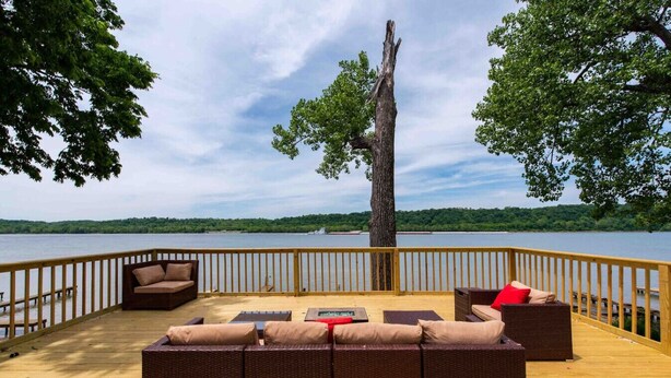 A deck with wicker furniture and a view of a lake. - Family/Pet-Friendly Riverside Home w/Amazing Views (Prospect)