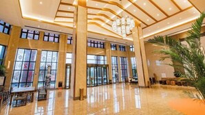 A spacious lobby with high ceilings, large windows, and a chandelier. - Heye Hotel (Anji)