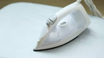 A white iron with a cord and a control knob.