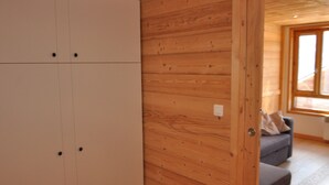 A room with wooden walls and a white wardrobe. - Charming studio in Châtel, near center, parking included (Châtel)