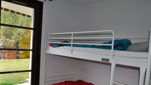 A bunk bed room with a window view of a grassy area and trees. - Apartment with terrace, ski locker and covered parking (Châtel)