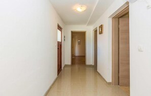 Stroll down this serene hallway to a door at the end.