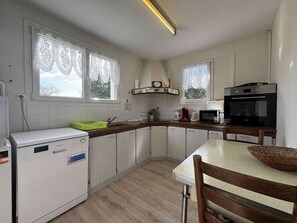 A compact kitchen with white cabinets, a microwave, a coffee maker, and a Sharp refrigerator. - Comfortable house in La Brée-les-Bains, near center and beach, WIFI included (La Brée-les-Bains)