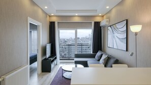 Deluxe Apartment | Living area | 50-inch Smart TV with digital channels, TV, Netflix