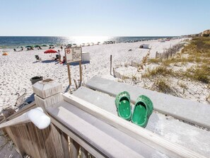 A beach with a wooden fence, green shoes, and a sign prohibiting class containers. - Waterscape A206 - Beautiful Family Paradise Resort! (Fort Walton Beach)