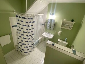 Combined shower/bathtub, towels - The Yellow House-Three bedroom within walking distance of Lake Michigan. (Ludington)