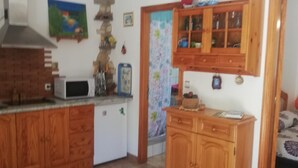 A kitchen with wooden cabinets, a microwave, and a small refrigerator. - Holiday Home "Casa Grenado" with Sea Views, Private Balcony & Wi-Fi (vallehermoso tazo)
