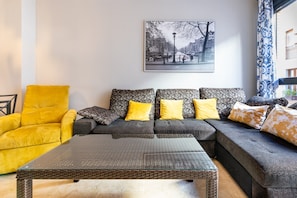 A living room with a sofa, armchair, and coffee table.