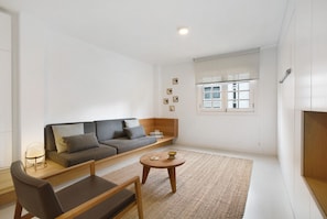 A modern living room with a sofa, a coffee table, and a chair. - Holiday Apartment 'La Alameda' with Sea View, Wi-Fi, and Air Conditioning (Santa Cruz de Tenerife)