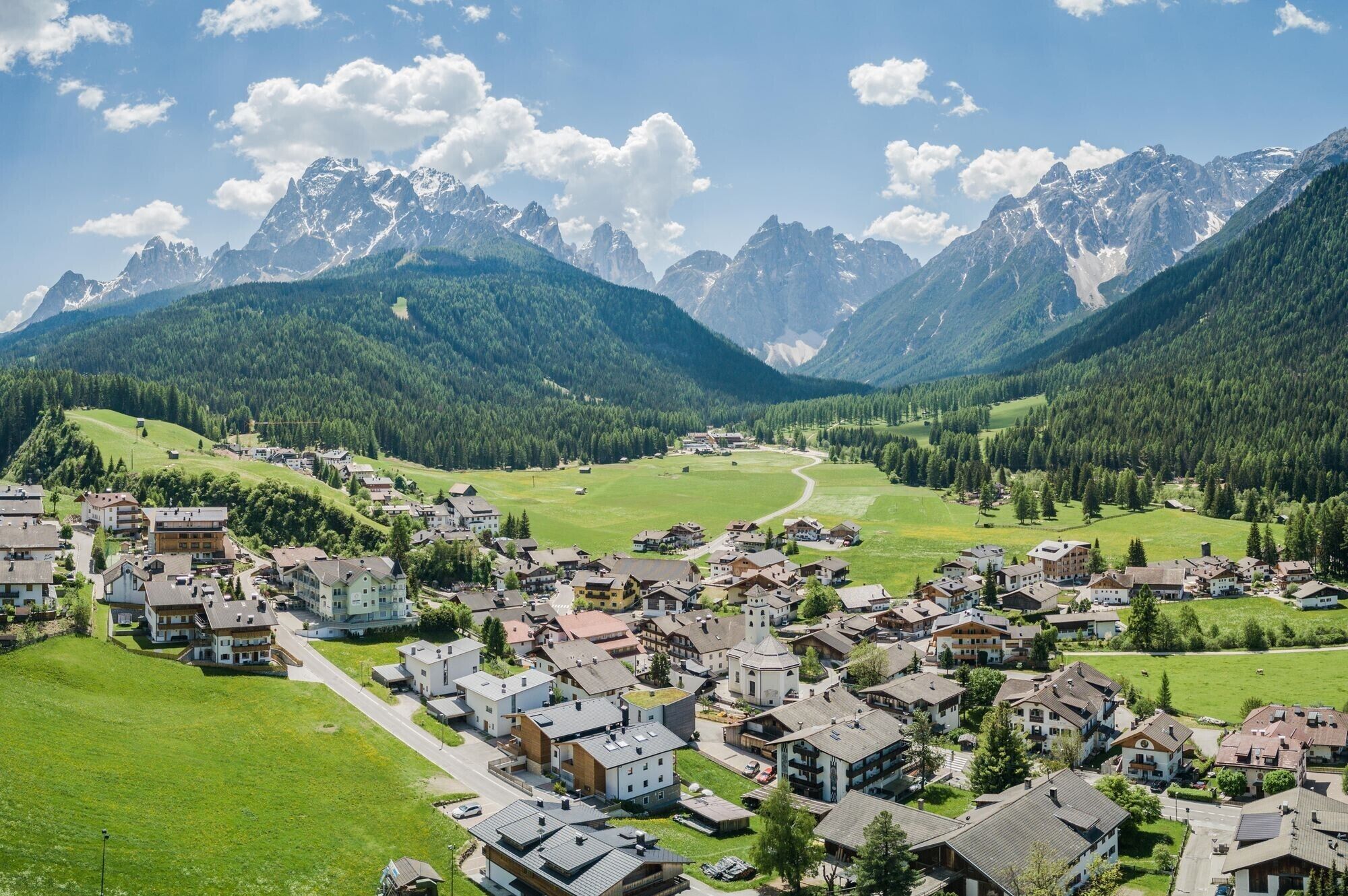 A mountain town with buildings, roads, and a valley.