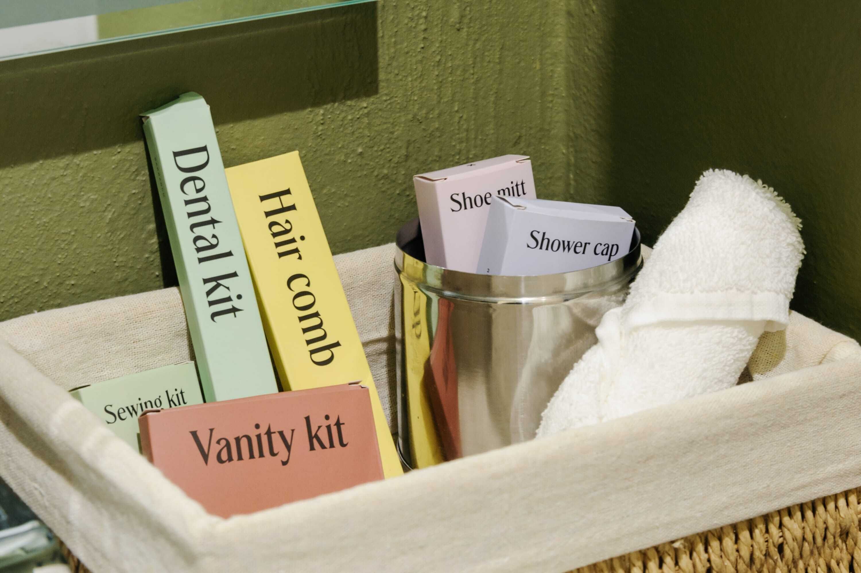 A toiletry kit with labeled items including a dental kit, hair comb, vanity kit, shoe mitt, and shower cap.