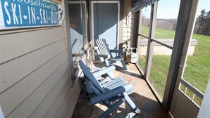 A covered outdoor area with a sign reading "Goosebumps Ski-In-Ski-Out" and several lounge chairs.