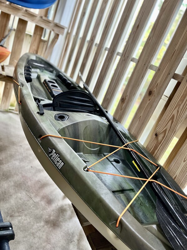 A kayak with a brand name visible, resting against a wooden fence. - Solaria: Waterfront, Heated Pool, Kayak, Fish/Golf, St George Island (Eastpoint)