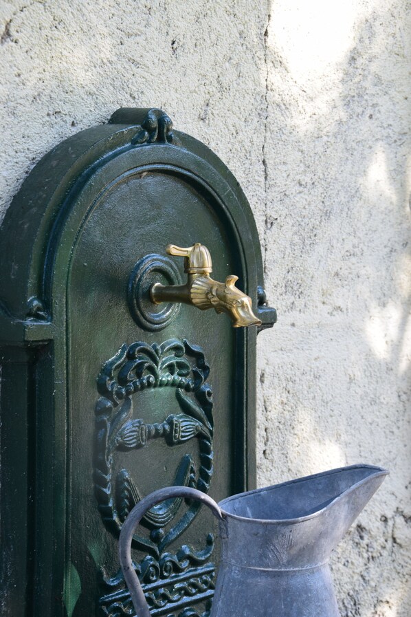 A door with a brass handle and a metal bucket attached to it.