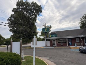 A building with a sign for Economy 7 Inn, a brick facade, and a parking lot.