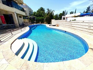 Outdoor pool, open 8:00 AM to 9:00 PM, sun loungers