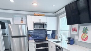 A modern kitchen with stainless steel appliances, a microwave, and a dishwasher. - Cozy spot next to Duval with swim spa - 2bed/2bath (Key West)