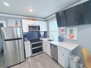 A modern kitchen with stainless steel appliances, a microwave, and a dishwasher.