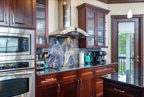 Enjoy cooking in this well-equipped kitchen with a microwave, oven, and coffee maker.