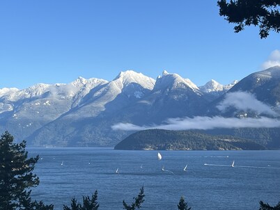 A cozy guest suite with a panoramic ocean view facing the Howe Sound Mountain 