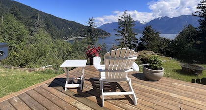 A cozy guest suite with a panoramic ocean view facing the Howe Sound Mountain