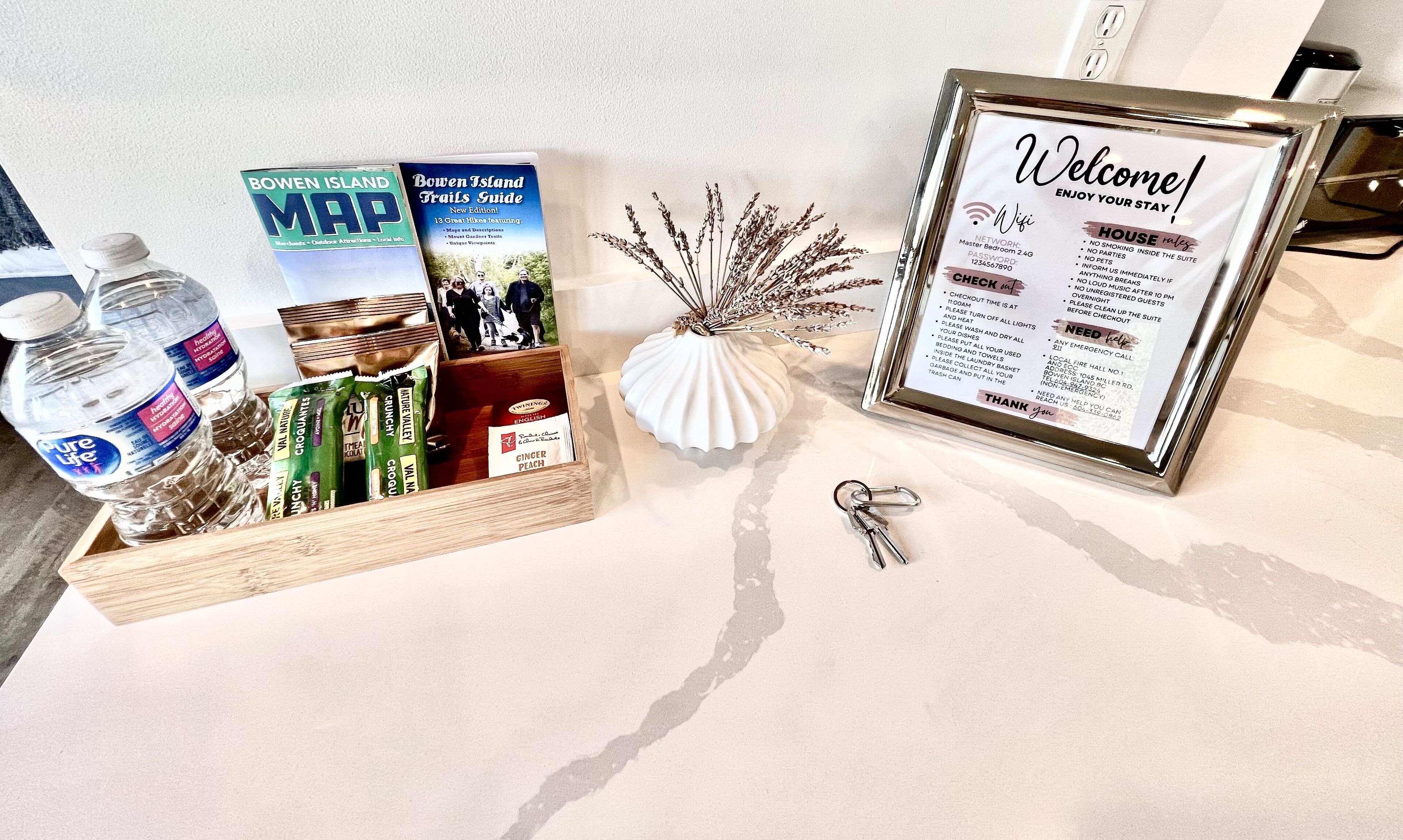 A welcome sign with hotel amenities and a small keychain.