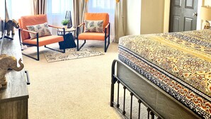 A bedroom with a bed, a chair, a desk, and a ceiling fan. - Historic Old Towne Southern Charm (Portsmouth)