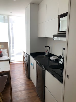 Fridge, microwave, coffee/tea maker, cookware/dishes/utensils