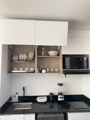 Fridge, microwave, coffee/tea maker, cookware/dishes/utensils