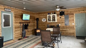 A cozy retreat room with a television, a coffee bar, and a fireplace. - Sweet Retreat West..sandy ORV's and memories made here (Mears)