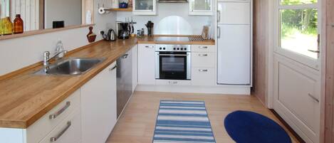 Fridge, stovetop, dishwasher, coffee/tea maker